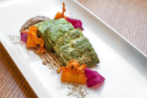 a white plate topped with food on a table at Feathers- A Radha Hotel, Chennai in Chennai
