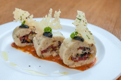a white plate with three food items on it at Feathers- A Radha Hotel, Chennai in Chennai
