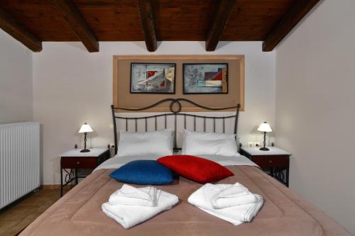 a bedroom with a bed with two pillows on it at Artemis Traditional Guesthouse in Levidhion