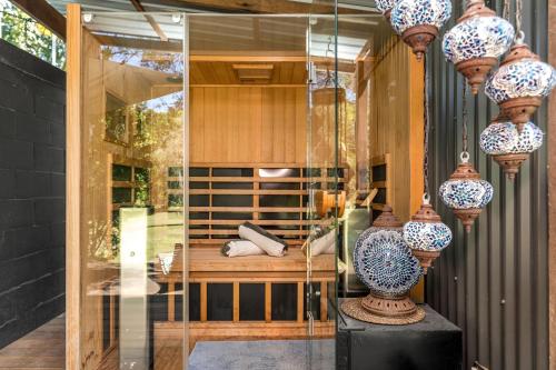 a glass room with a vase on a table at Figtree Creek Retreat in The Pocket