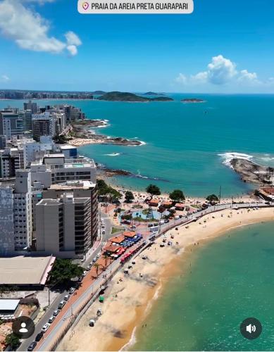 an aerial view of a beach and the ocean at Ambiente familhiar in Guarapari