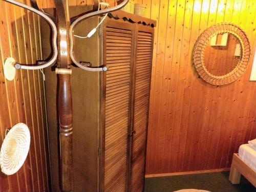 a bathroom with a shower with a wooden wall at Ferienhaus Waldkrone in Arrach