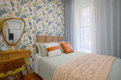 a bedroom with a bed and a mirror at Classy 2BD Home in Manhattan in New York