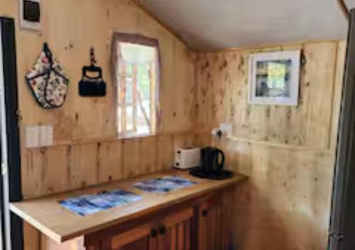 a small kitchen with a counter and a window at Deltrade Wedding and Camp in Pretoria