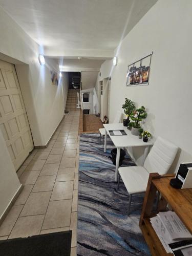 a hallway with a table and chairs in a room at SMB home PANORAMA in Oradea