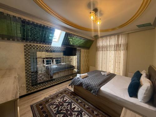 a bedroom with a large bed and a fireplace at Villa lux in Qusar