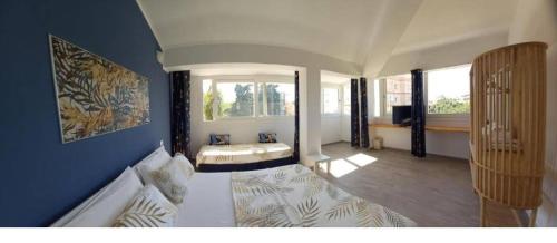 a living room with a bed and a large window at Stasonis in Quartu SantʼElena