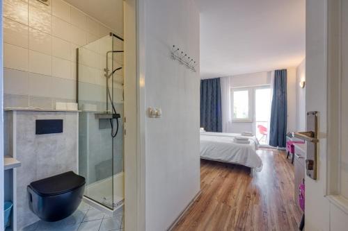 a bathroom with a shower and a bed in a room at Martin's B&B in Dramalj