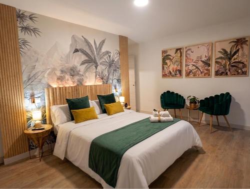 a bedroom with a large bed with yellow and green pillows at Ciudad Rodrigo Centro VuT in Ciudad-Rodrigo