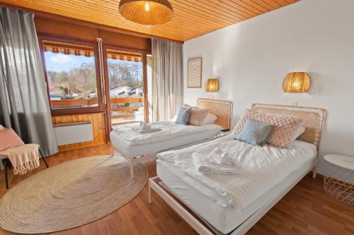 a living room with two beds and a balcony at Cari'Stay in Portalban- Dessous