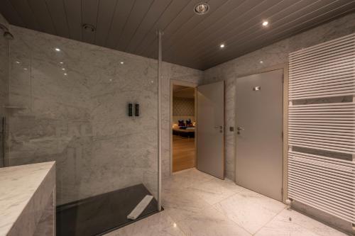 a bathroom with a shower with a glass wall at Hotel Falko in Meise