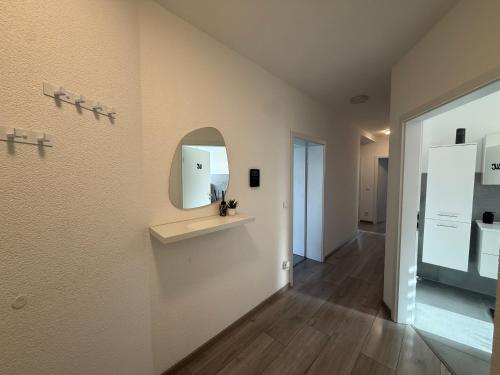a room with a mirror and a hallway at Sauerland Wellness Apartment mit Sauna und Jacuzzi in Olpe