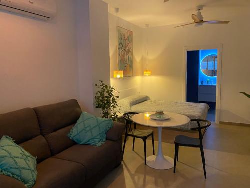 a living room with a couch and a table at Santa Pola Suites - Self Check-in near Beach in Santa Pola