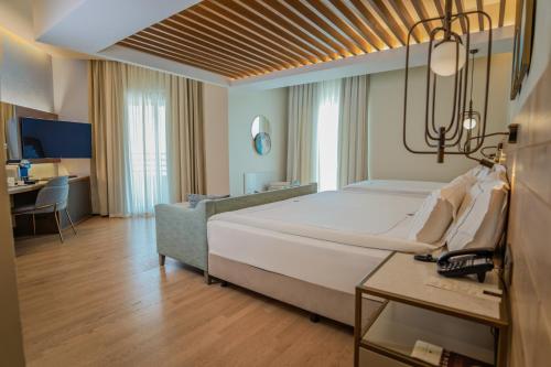 a large bedroom with a large bed and a couch at Miramare Beach Hotel - Ultra All Inclusive in Side