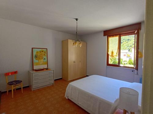 a bedroom with a bed and a dresser and a window at Casa Noemi in IDRO