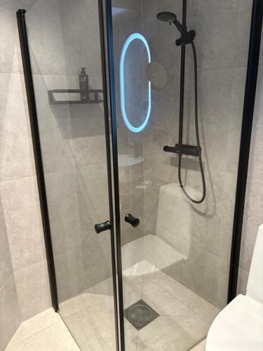 a shower with a glass door in a bathroom at Laholms Stadshotell in Laholm