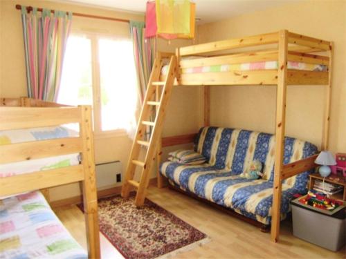 a bedroom with two bunk beds and a ladder at Résidence 502-pleneuf Val Andre - Charmante maison de 85m², avec jardin clos dans un quartier calme. MAE-6674 in Pléneuf-Val-André