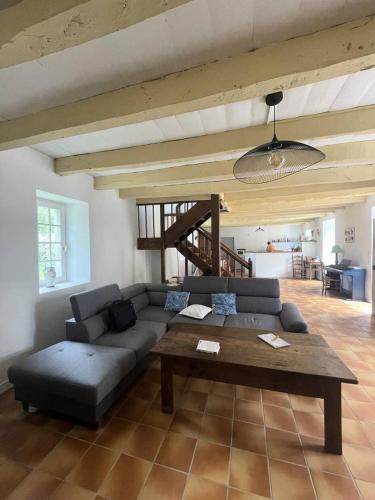 a living room with a couch and a table at Résidence 740-pleneuf Val Andre - Belle maison en pierre offrant de beaux volumes à 2km dans la de Pleneuf Val André MAE-8554 in Pléneuf-Val-André