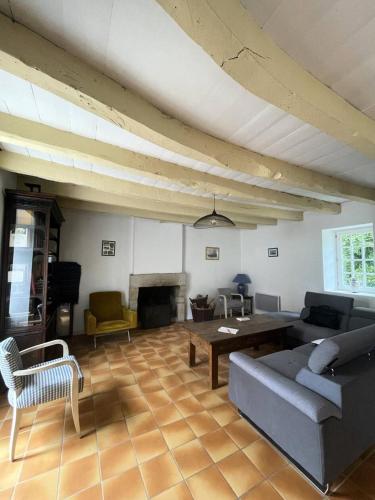 a living room with a couch and a table at Résidence 740-pleneuf Val Andre - Belle maison en pierre offrant de beaux volumes à 2km dans la de Pleneuf Val André MAE-8554 in Pléneuf-Val-André