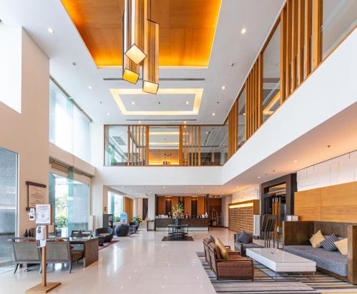 an open lobby with couches and tables and windows at Kantary Hotel Ayutthaya in Phra Nakhon Si Ayutthaya