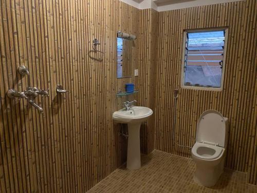 a bathroom with a toilet and a sink at Hotel The Mint Garden in Pokhara