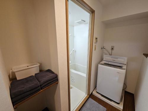 a small bathroom with a toilet and a shower at Namba Ebisu Tower701 in Osaka