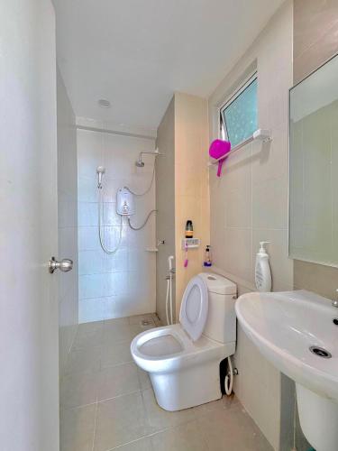 a bathroom with a toilet and a sink and a shower at Ezae Studio D'Perdana Apartment in Kota Bharu