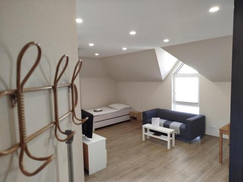 a living room with a couch and a bed at Appartement Design 2 - Altenstadt in Altenstadt