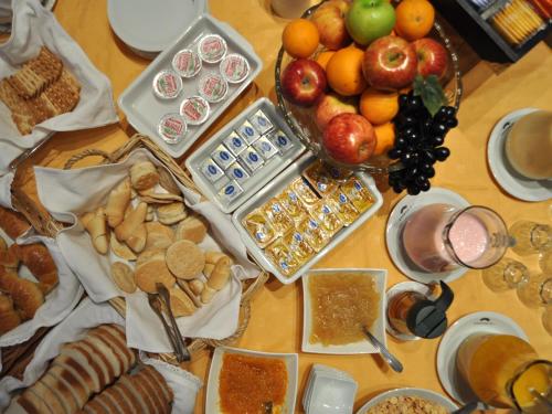 a table with a bunch of different types of food at Gregorio I Hotel Boutique in San Salvador de Jujuy