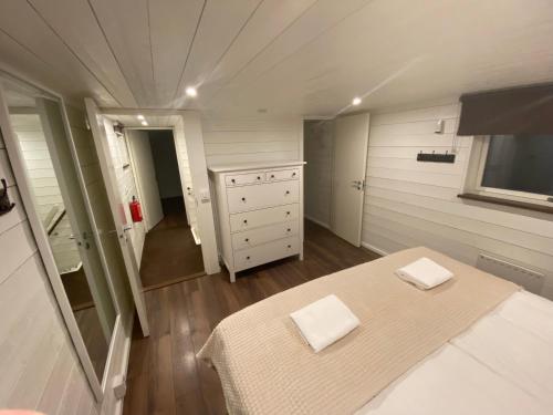 a small bedroom with a bed and a dresser at Port Hotel Ocean Villa in Karlshamn