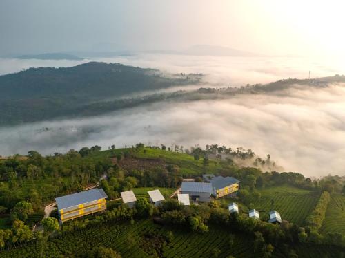 a train station on a hill with a foggy field at The Hosteller Bam Vagamon in Vagamon
