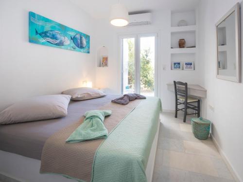 a bedroom with a bed with a towel on it at Villa Ione in Mikri Vigla