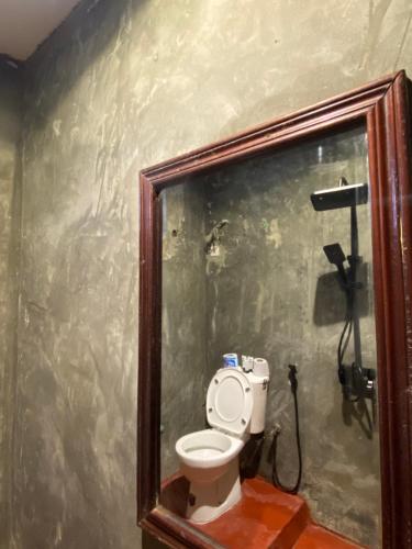 a bathroom with a white toilet in a room at Hello Rafiki Hotel Stone town in Ngambo