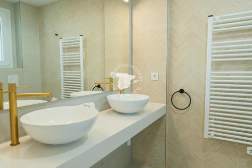 a bathroom with two white bowls on a counter at Silver Tower 9A in Ifach