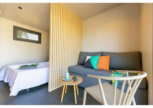 a living room with a couch and a table at Camping les Oliviers in Oraison