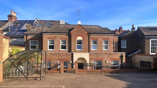 a brick building with a gate in front of it at Ibis House by Viridian Apartments in Richmond