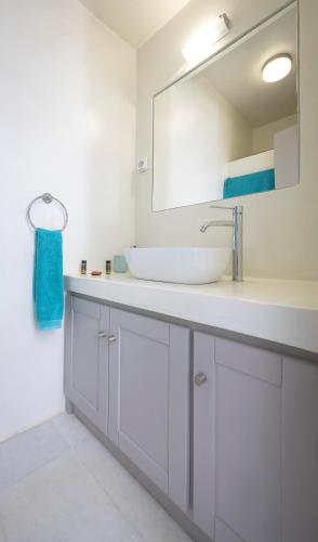 a bathroom with a sink and a mirror at Villa Ione in Mikri Vigla