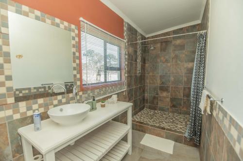 a bathroom with a sink and a shower at Accommodation on 3329 - Unit 2 in Gqeberha