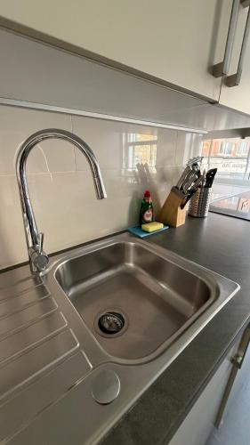 a stainless steel sink in a kitchen at Ibis House by Viridian Apartments in Richmond