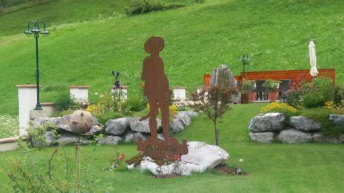 a statue of a girl standing on a rock in a garden at Ferienhaus am Lechweg in Steeg