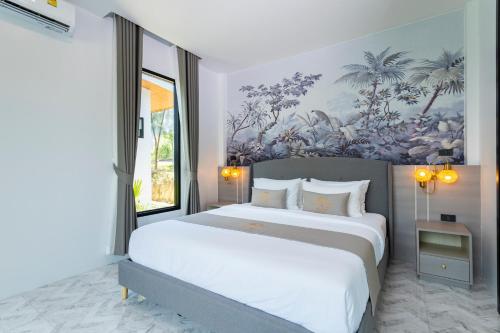 a bedroom with a large bed with a painting on the wall at Nanuea Village Ao Nang in Ao Nang Beach