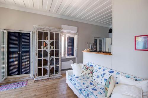 a living room with a couch and some windows at Blue Horizon Residence in Mitika
