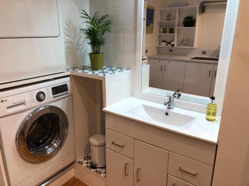 a bathroom with a sink and a washing machine at The Nook in Padstow