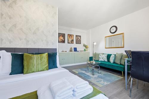a living room with a bed and a couch at Luxury Kensington Apt - Walk to Harrods in London