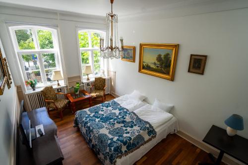 a bedroom with a bed with a blue and white blanket at Hotel Allegade 10 in Copenhagen