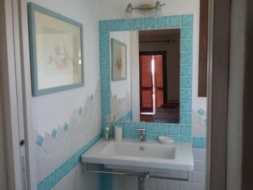 a bathroom with a sink and a mirror at Villa Lilly 2 in Punta Molara