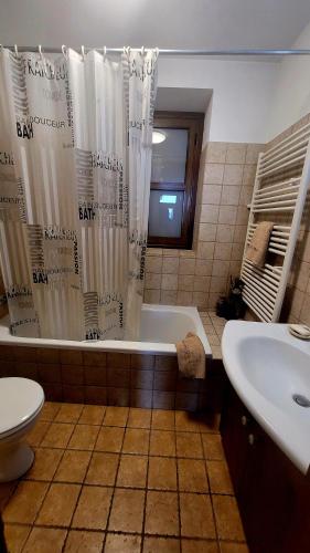 a bathroom with a tub and a toilet and a sink at CasaLambra Pedoulas Exclusive Accomodation Troodos Mountains in Pedoulas