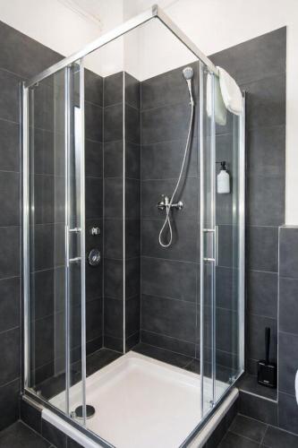 a shower with a glass enclosure in a bathroom at Hotel Hamburg Nord in Norderstedt