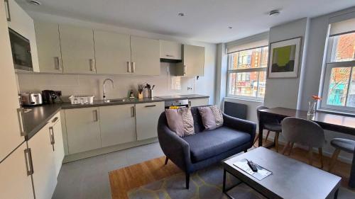 a kitchen and living room with a couch and a table at Ibis House by Viridian Apartments in Richmond