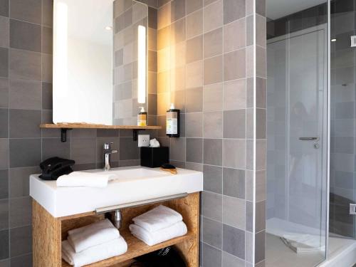 a bathroom with a sink and a shower at greet Hotel Rennes Pace in Pacé